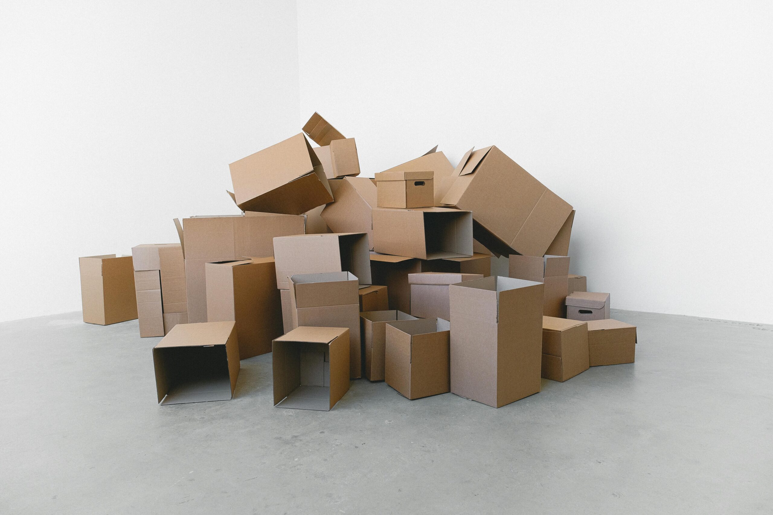 Stack of carton boxes on floor in rented house